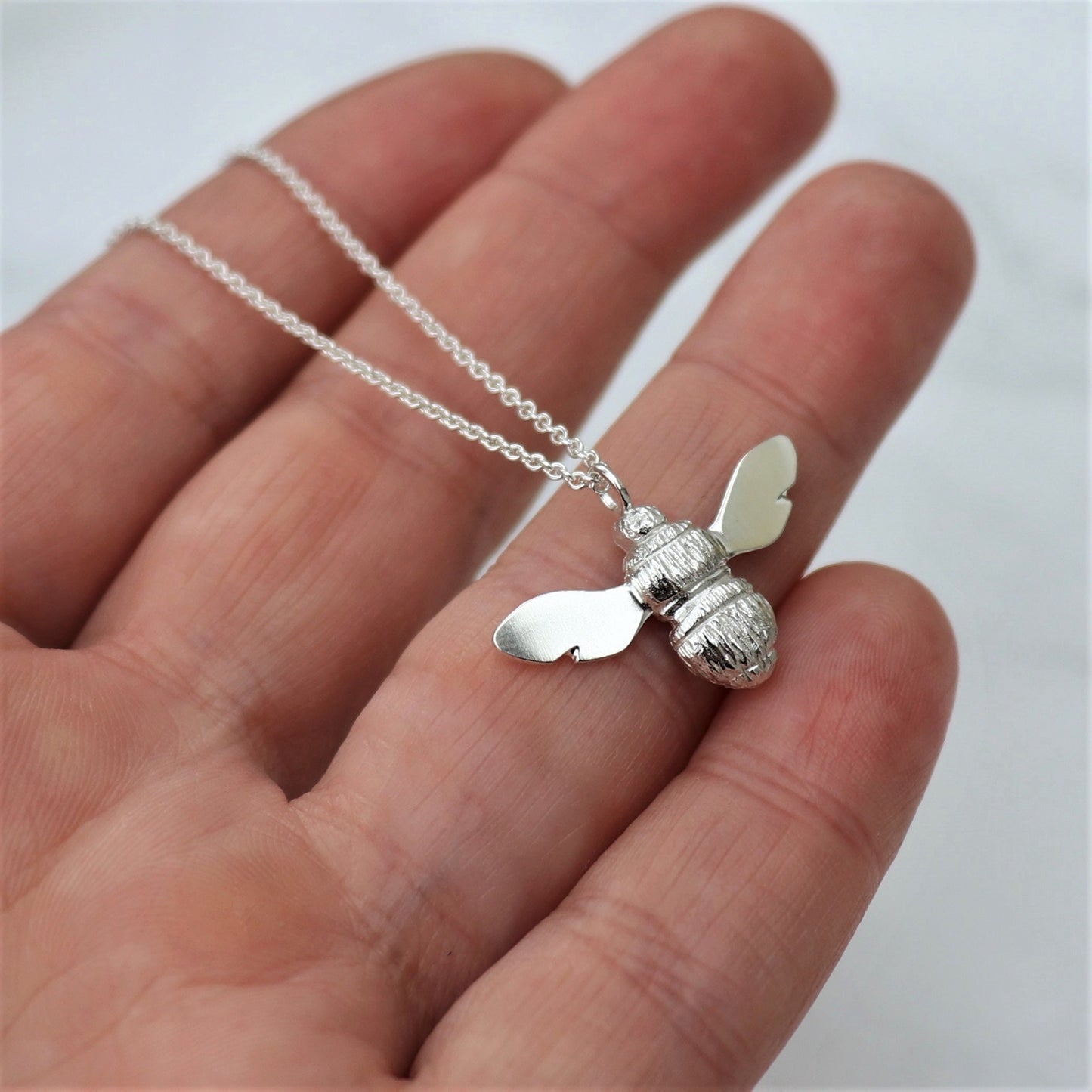 Solid silver garden bumblebee pendant on a trace chain