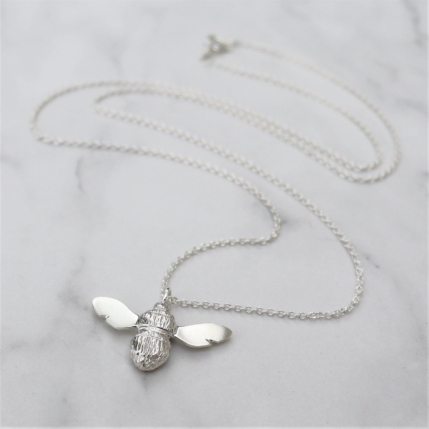 Solid silver garden bumblebee pendant on a trace chain
