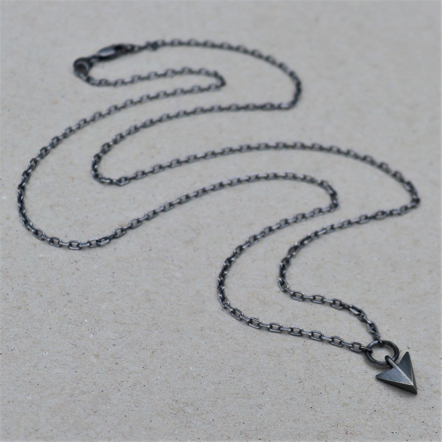 Solid silver arrow loop detail pendant on a diamond cut trace chain - Oxidised or polished