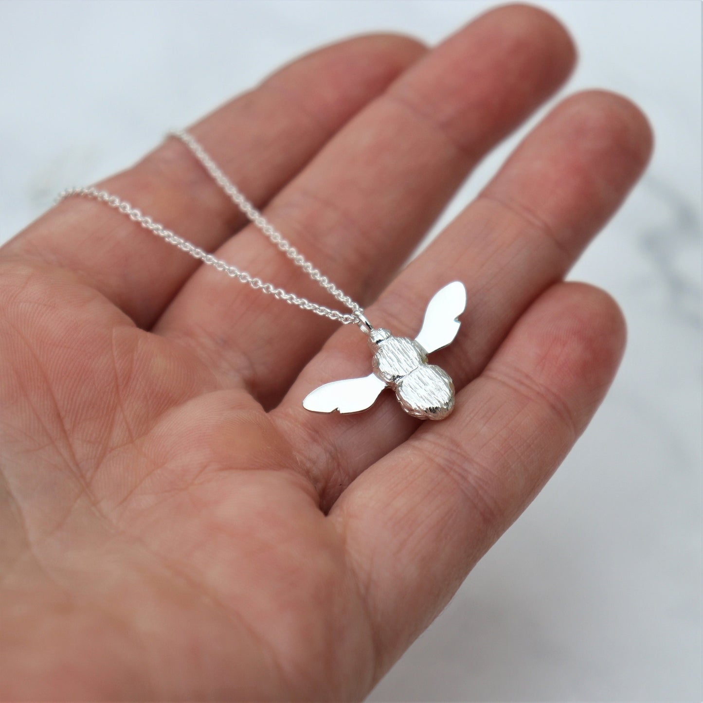 Solid silver garden bumblebee pendant on a trace chain