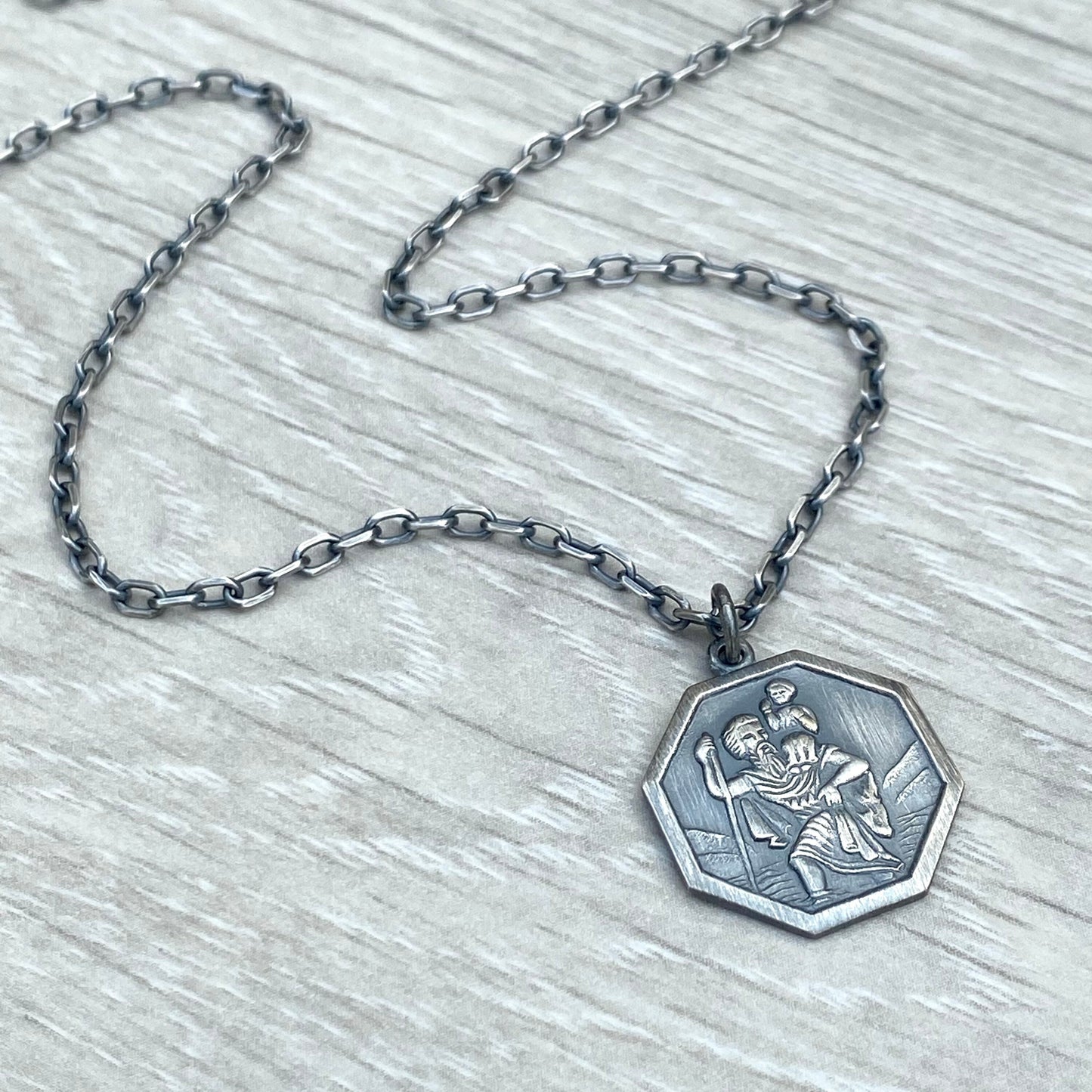 Oxidised or polished solid silver octagonal Saint Christopher pendant on a diamond cut trace chain