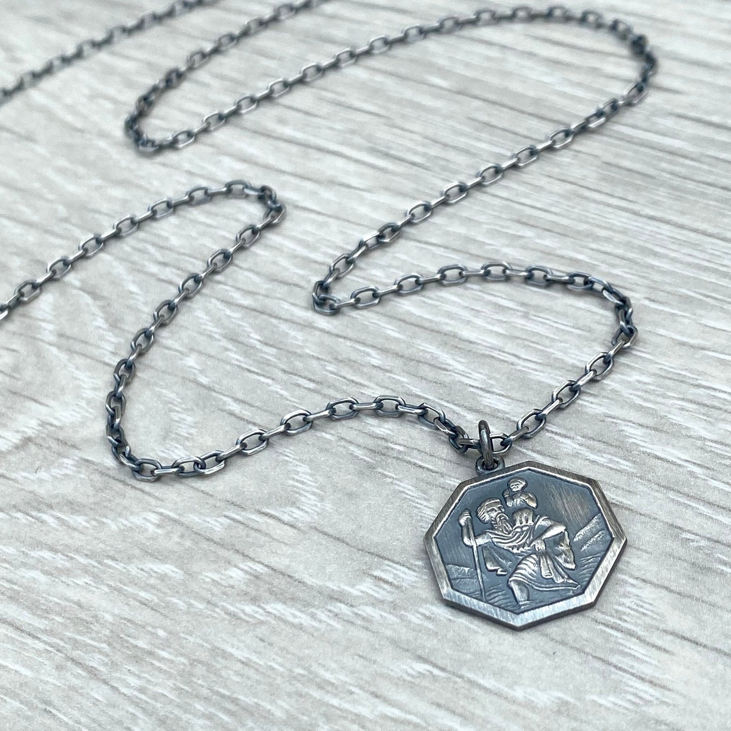 Oxidised or polished solid silver octagonal Saint Christopher pendant on a diamond cut trace chain