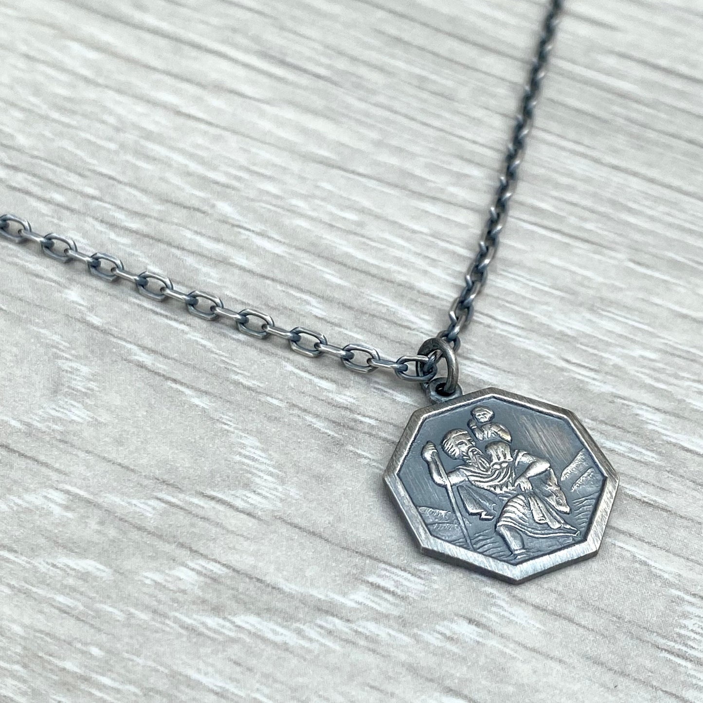 Oxidised or polished solid silver octagonal Saint Christopher pendant on a diamond cut trace chain