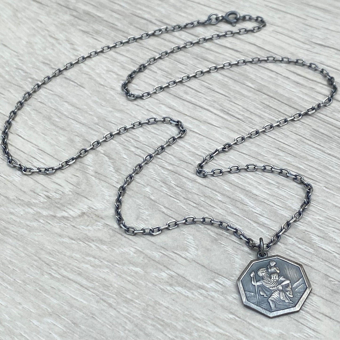 Oxidised or polished solid silver octagonal Saint Christopher pendant on a diamond cut trace chain
