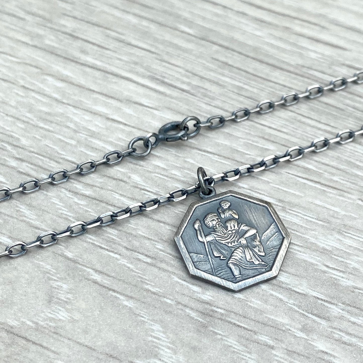 Oxidised or polished solid silver octagonal Saint Christopher pendant on a diamond cut trace chain