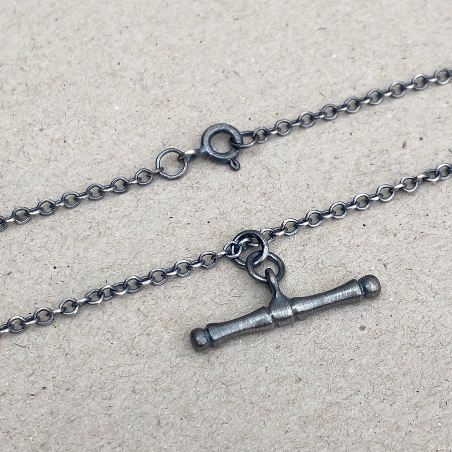 Oxidised or polished solid silver T-bar pendant on a trace chain
