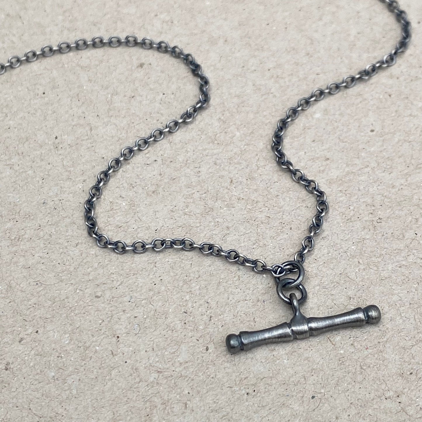 Oxidised or polished solid silver T-bar pendant on a trace chain