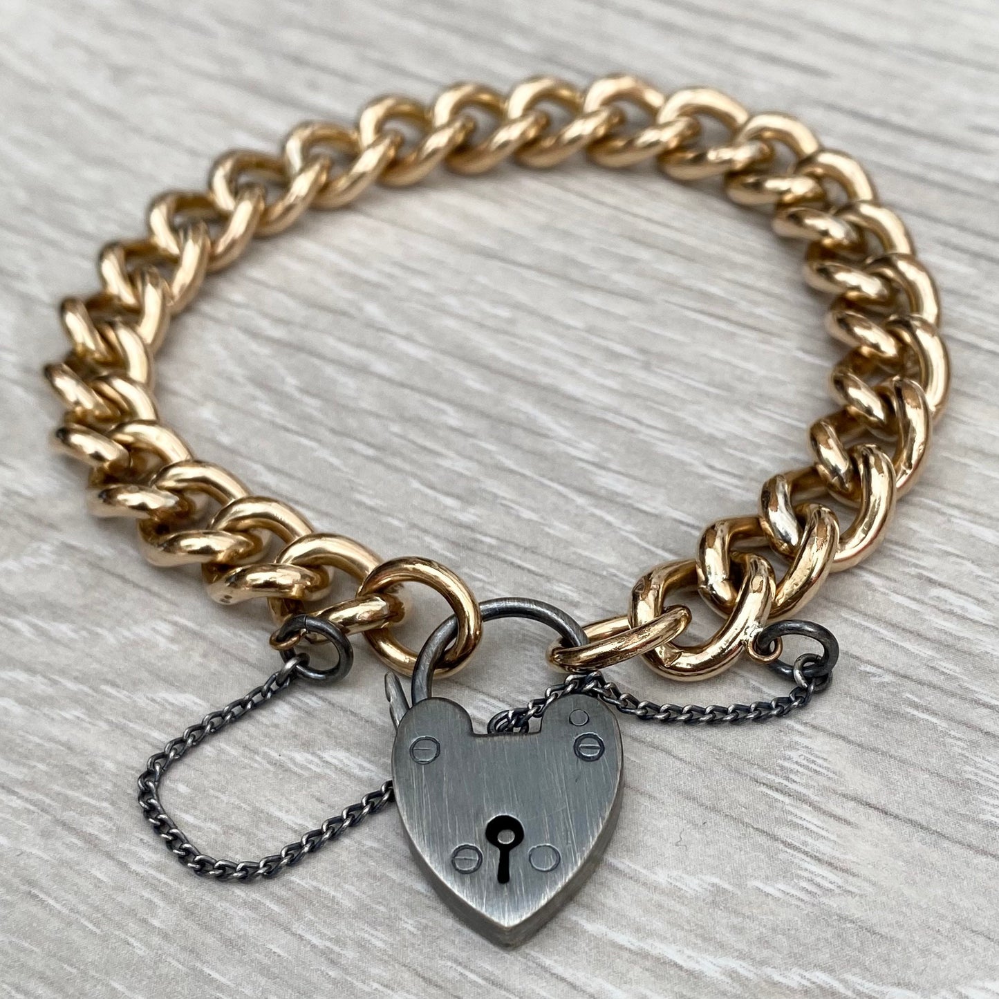 Vintage rolled gold curb chain 7.5" bracelet with a renewed oxidised silver heart locket