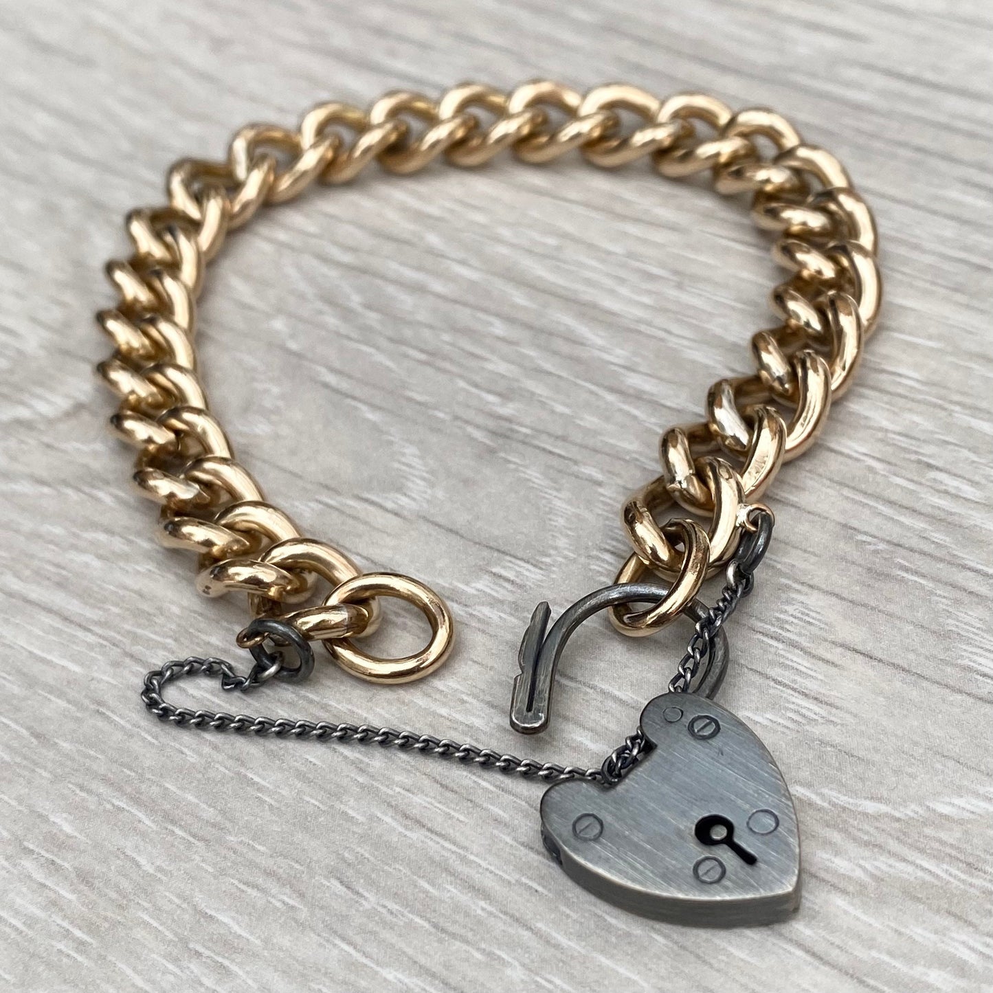 Vintage rolled gold curb chain 7.5" bracelet with a renewed oxidised silver heart locket