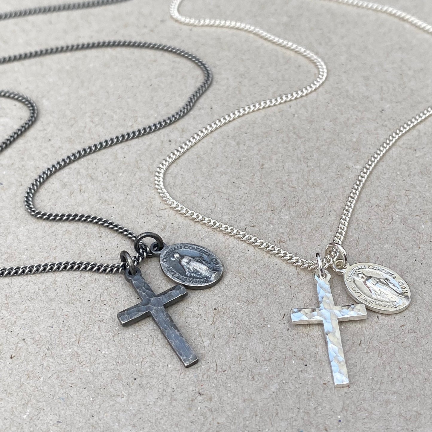 Oxidised or polished small solid silver hammered cross pendant and petite Miraculous Medal on a curb chain