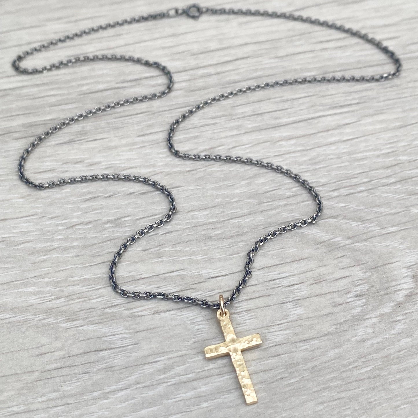 Polished small size 9ct yellow gold hammered cross pendant on a oxidised silver round box chain