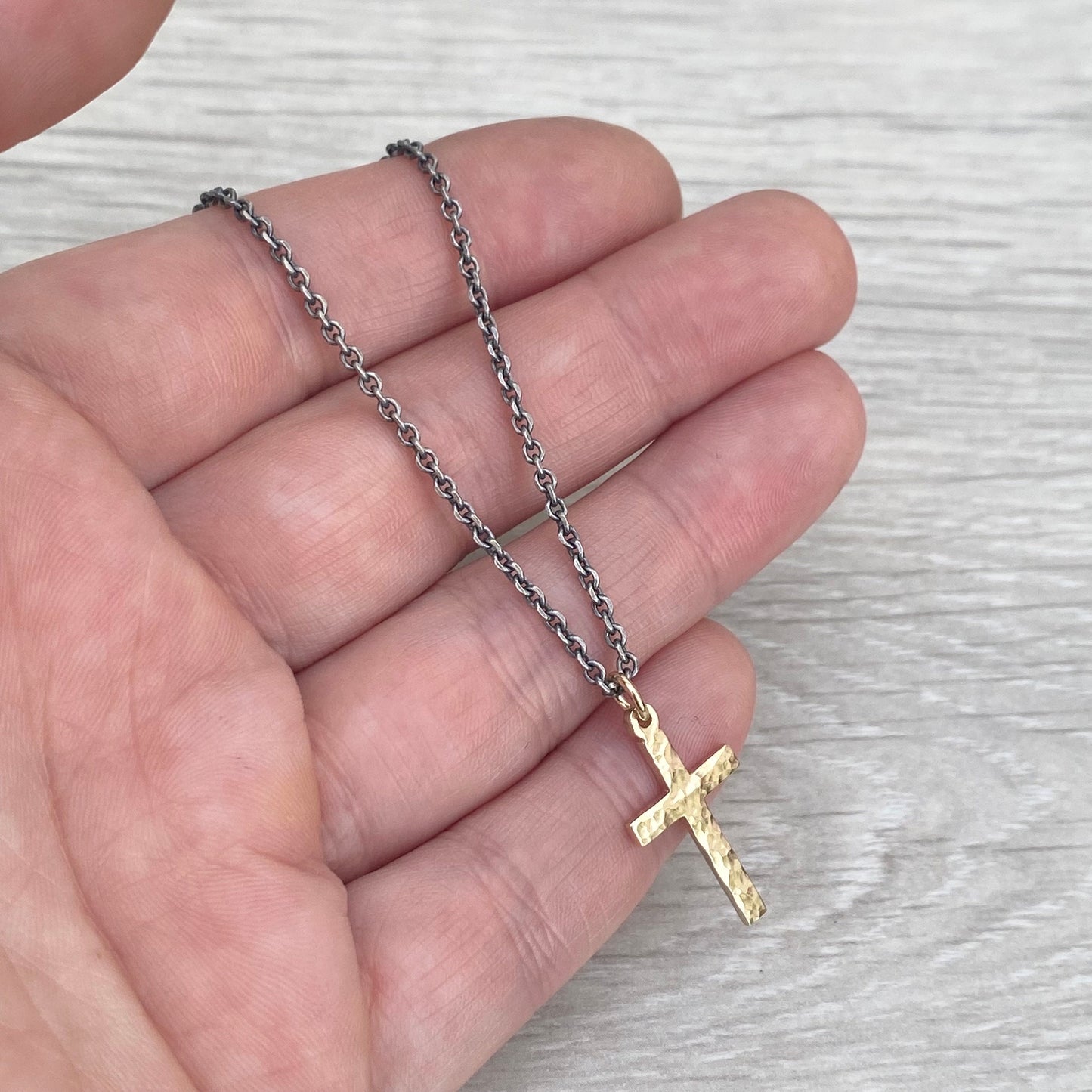 Polished small size 9ct yellow gold hammered cross pendant on a oxidised silver round box chain