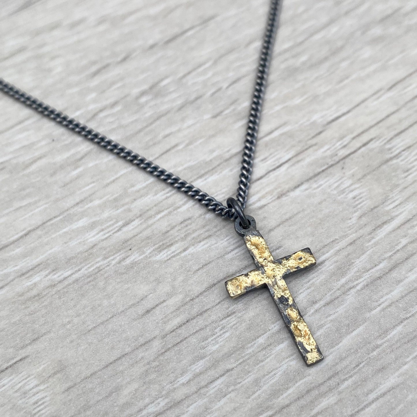 Oxidised reticulated silver and gold small size cross pendant on a 22" curb chain