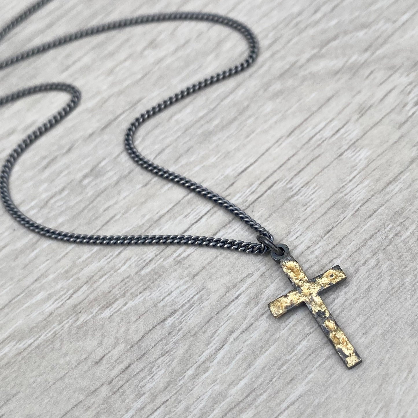 Oxidised reticulated silver and gold small size cross pendant on a 22" curb chain