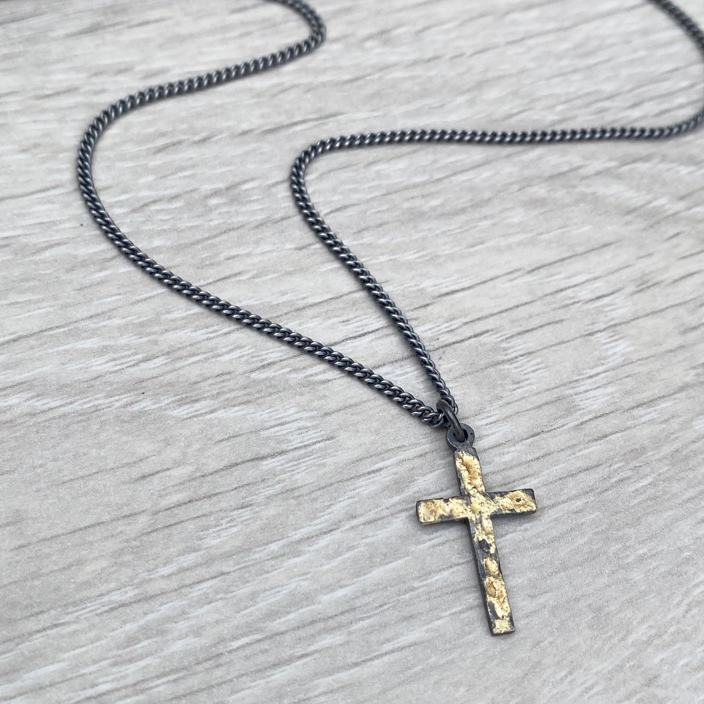 Oxidised reticulated silver and gold small size cross pendant on a 22" curb chain