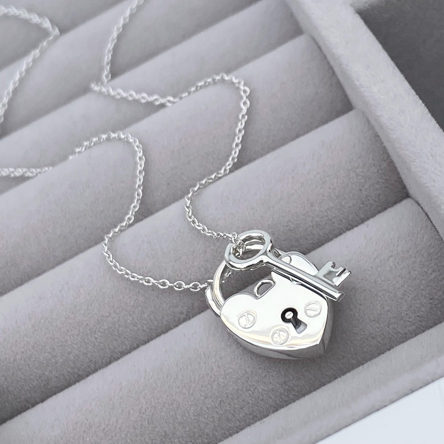 Solid silver heart padlock and dainty key charm pendant on a trace chain