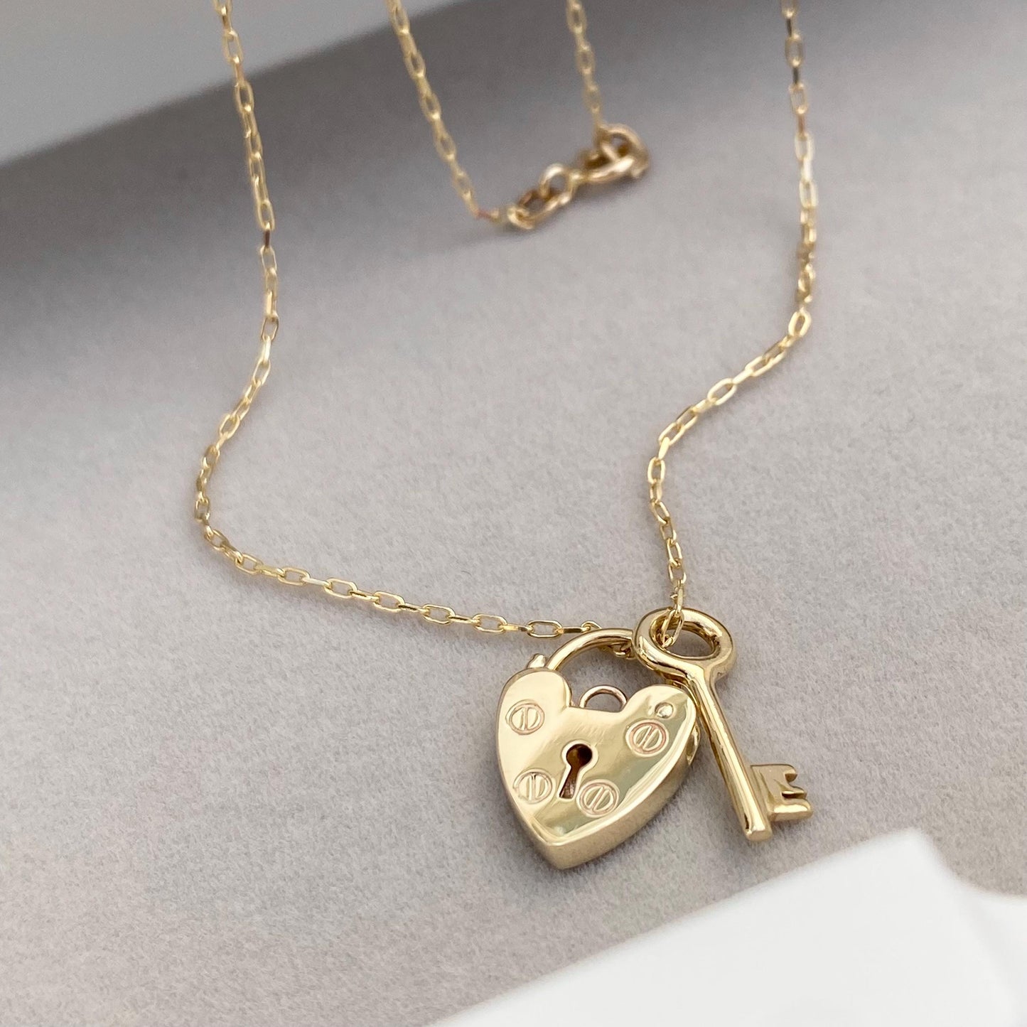 9ct solid yellow gold heart padlock and small key charm pendants on a trace chain