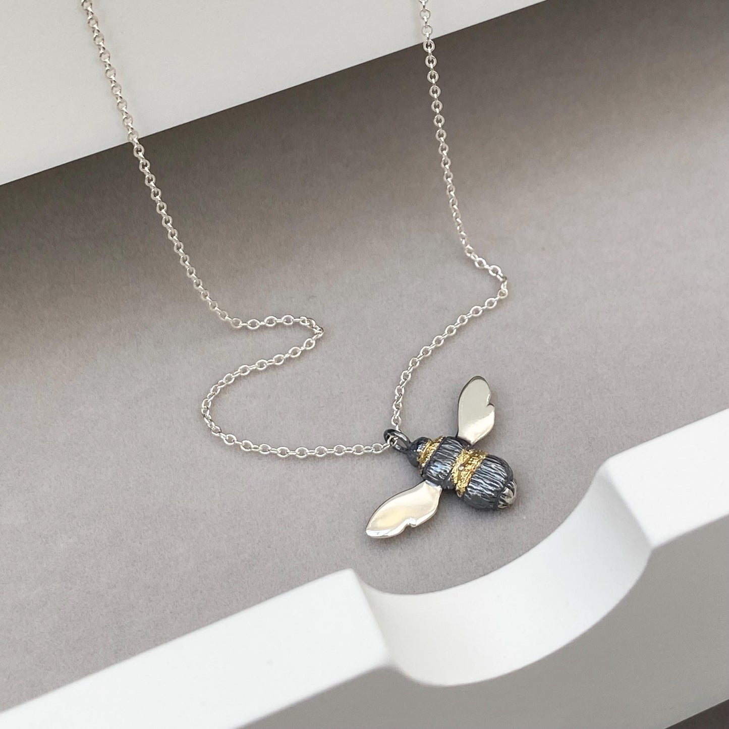 Oxidised solid silver and gold detail Bumblebee pendant on a silver trace chain