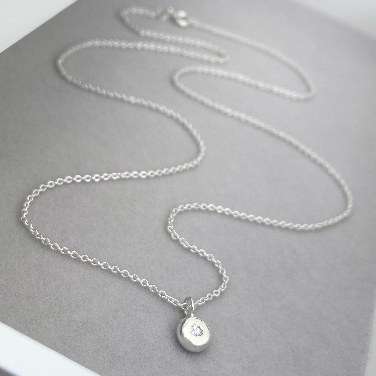 Handmade 2mm round natural diamond silver nugget pendant on a trace chain