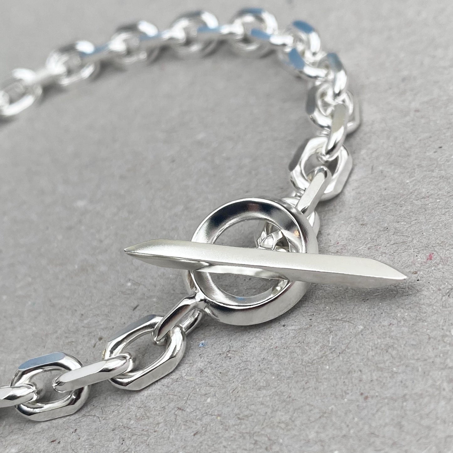 Oxidised or polished solid silver 6.6mm wide diamond cut trace chain bracelet with a unique T-bar design