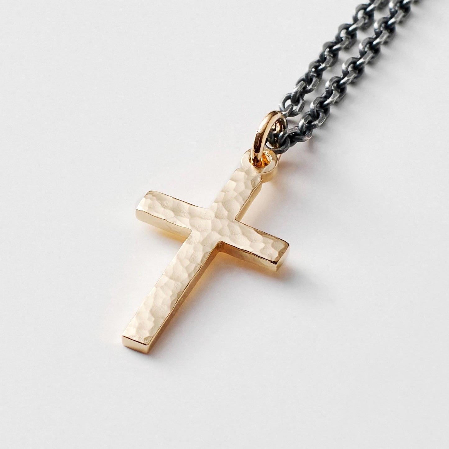 Polished small size 9ct yellow gold hammered cross pendant on a oxidised silver round box chain