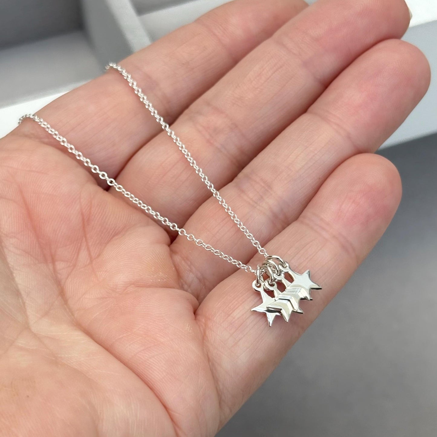 Sterling silver tiny star charm pendants on a trace chain