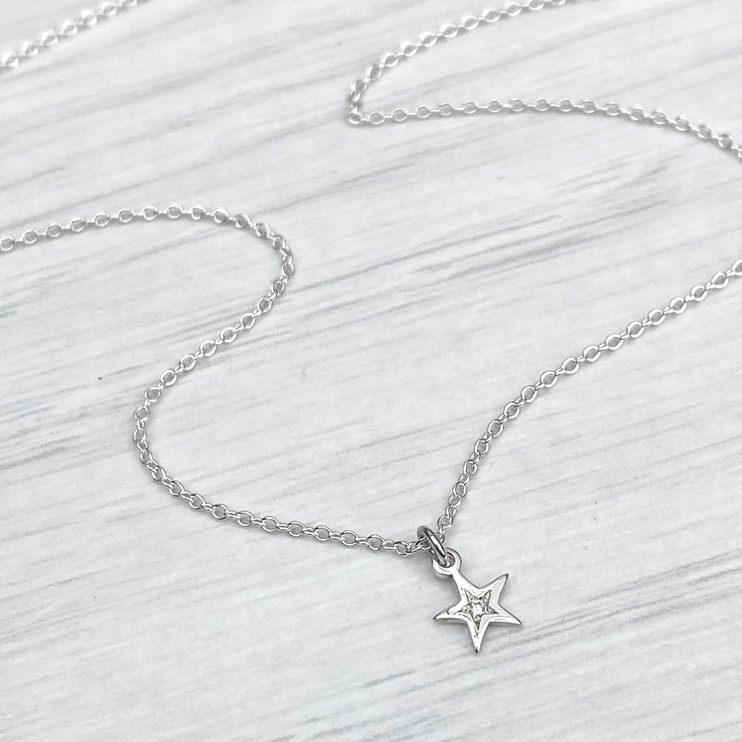 Sterling silver star engraved diamond tiny star charm pendant on a 1.2mm wide trace chain