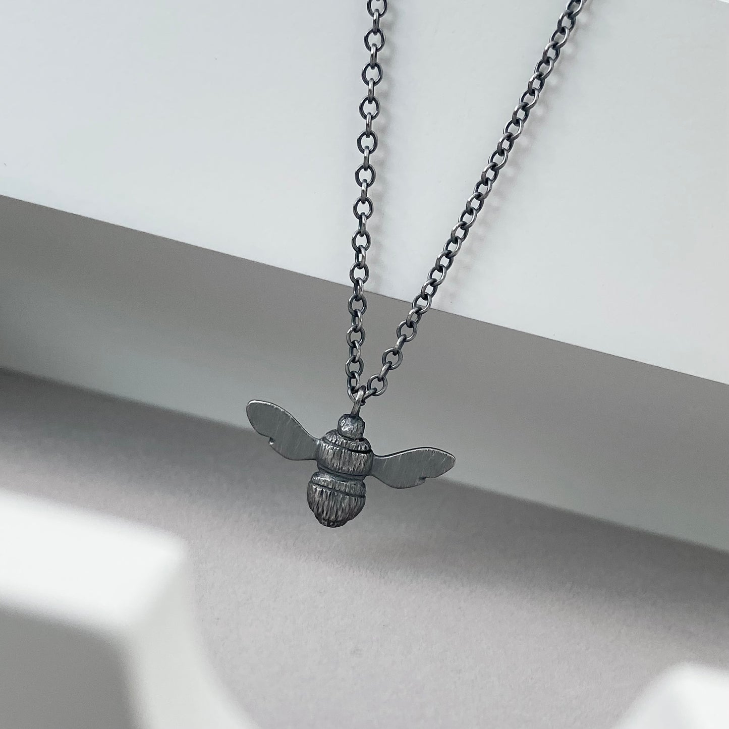 Oxidised solid sterling silver garden bumblebee pendant on a trace chain
