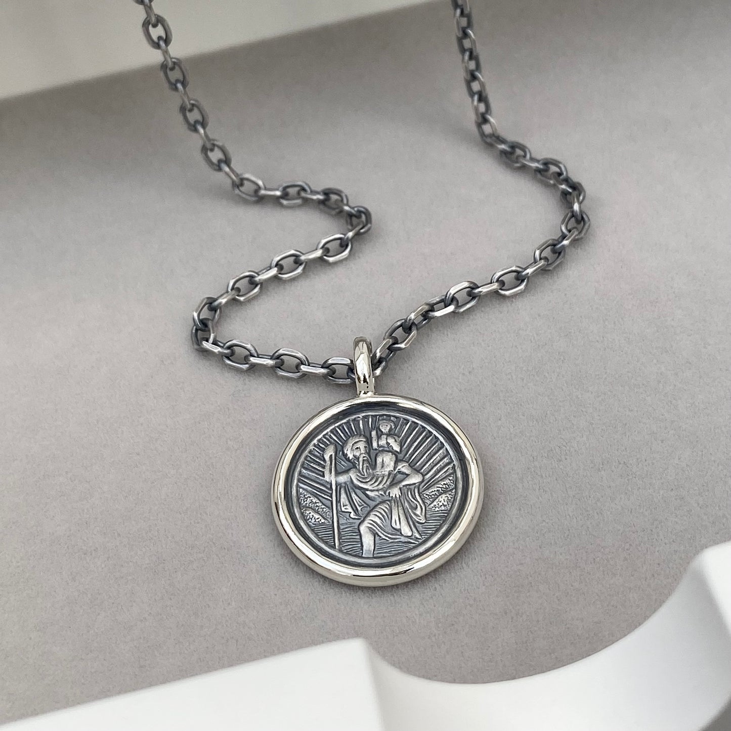 Oxidised solid silver Saint Christopher circle framed pendant on a 2.9mm wide diamond cut trace chain