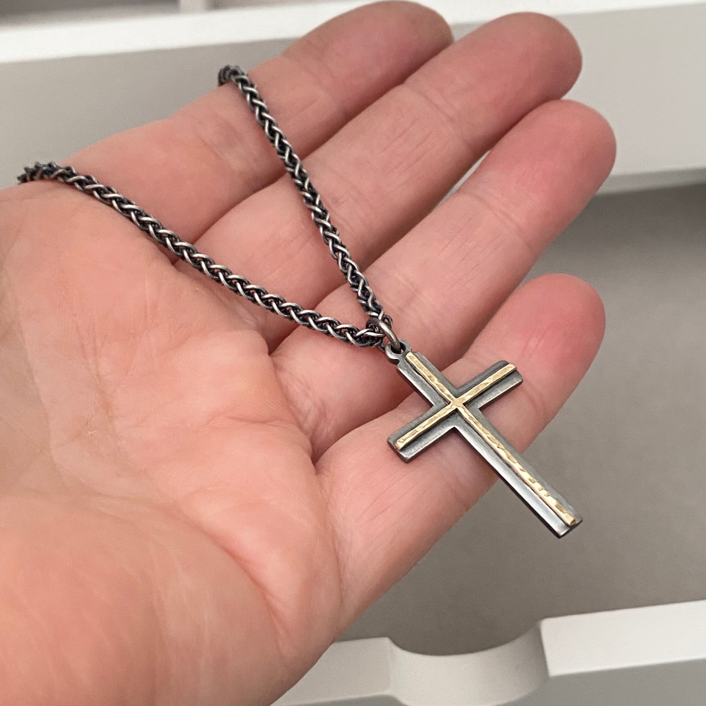 Oxidised solid sterling silver and hammered 9ct yellow gold medium cross pendant on an oxidised silver spiga chain
