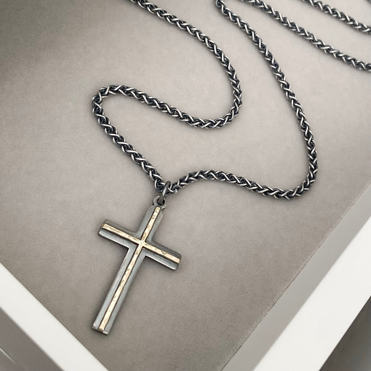 Oxidised solid sterling silver and hammered 9ct yellow gold medium cross pendant on an oxidised silver spiga chain