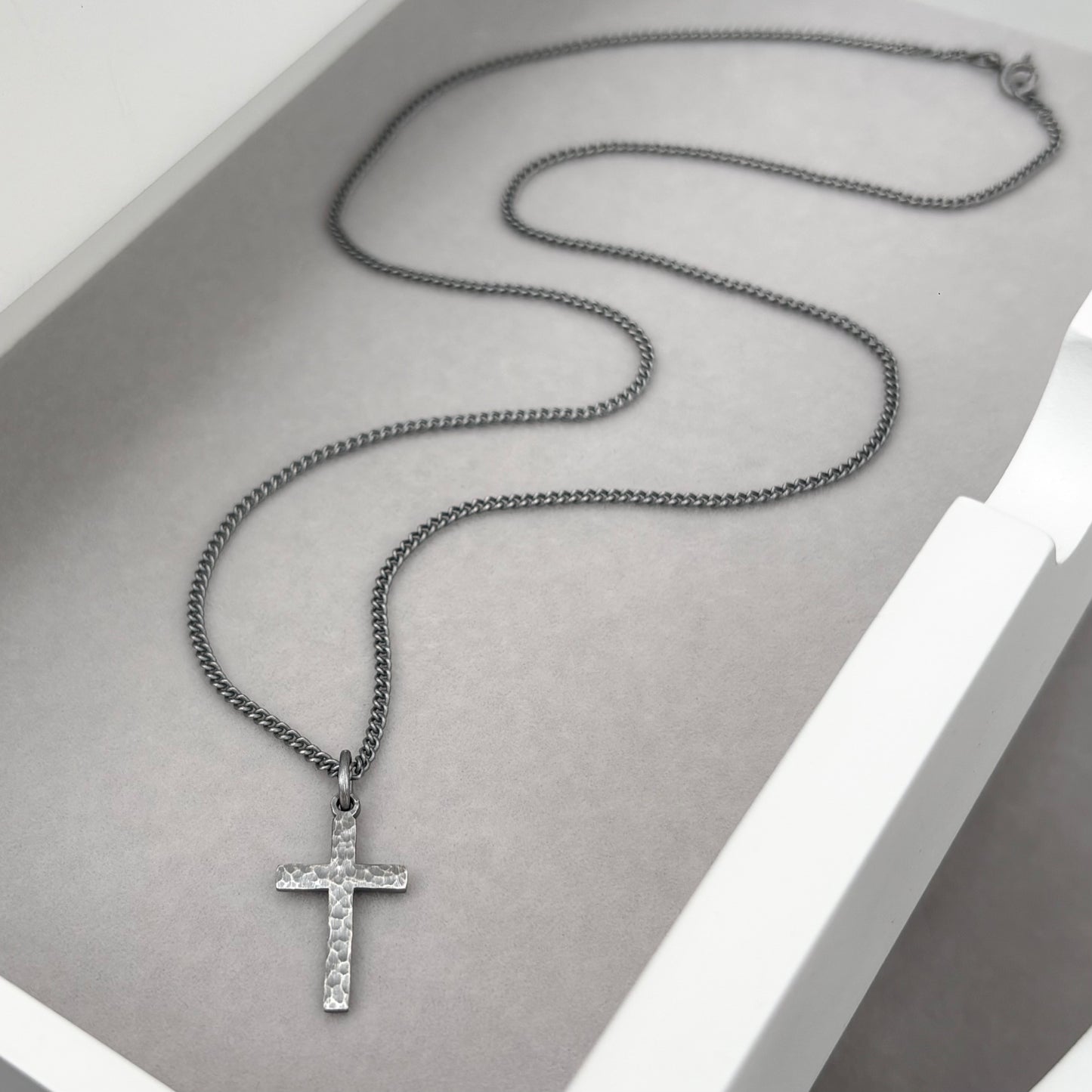 Oxidised sterling silver hammered finish small, standard, and medium cross pendants on a curb chain