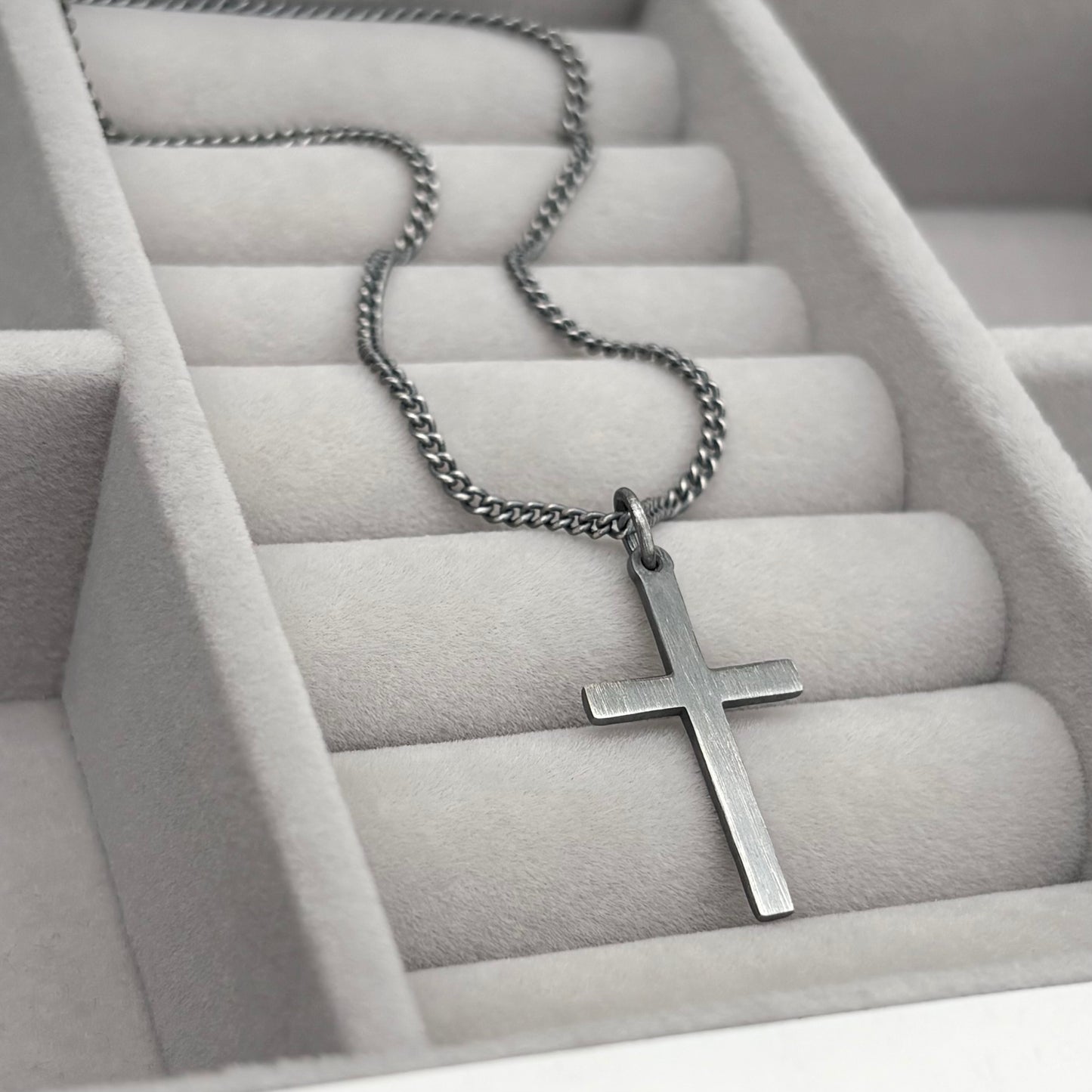 Oxidised sterling silver hammered finish small, standard, and medium cross pendants on a curb chain