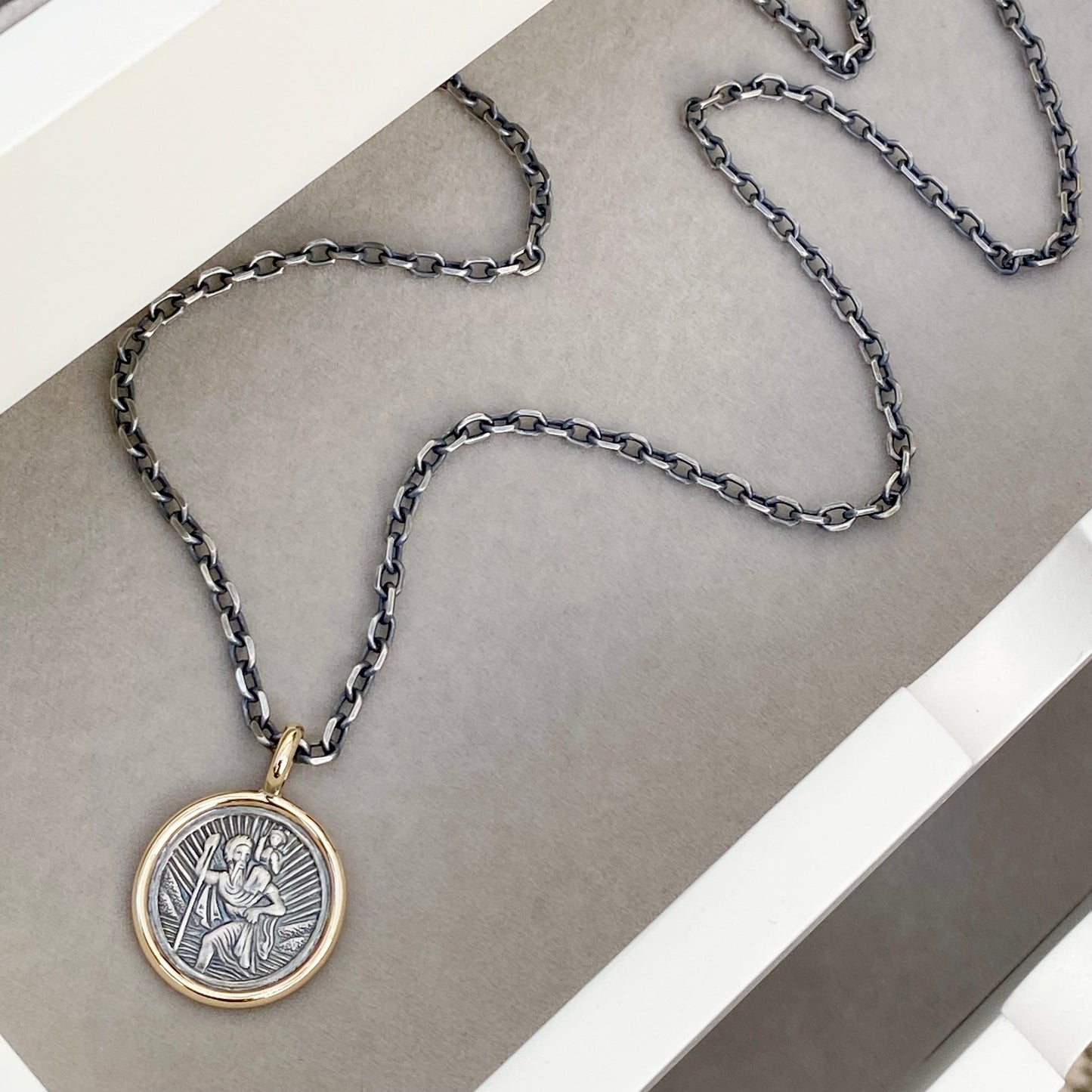 Oxidised solid silver round Saint Christopher 9ct yellow gold framed pendant on diamond cut trace chain