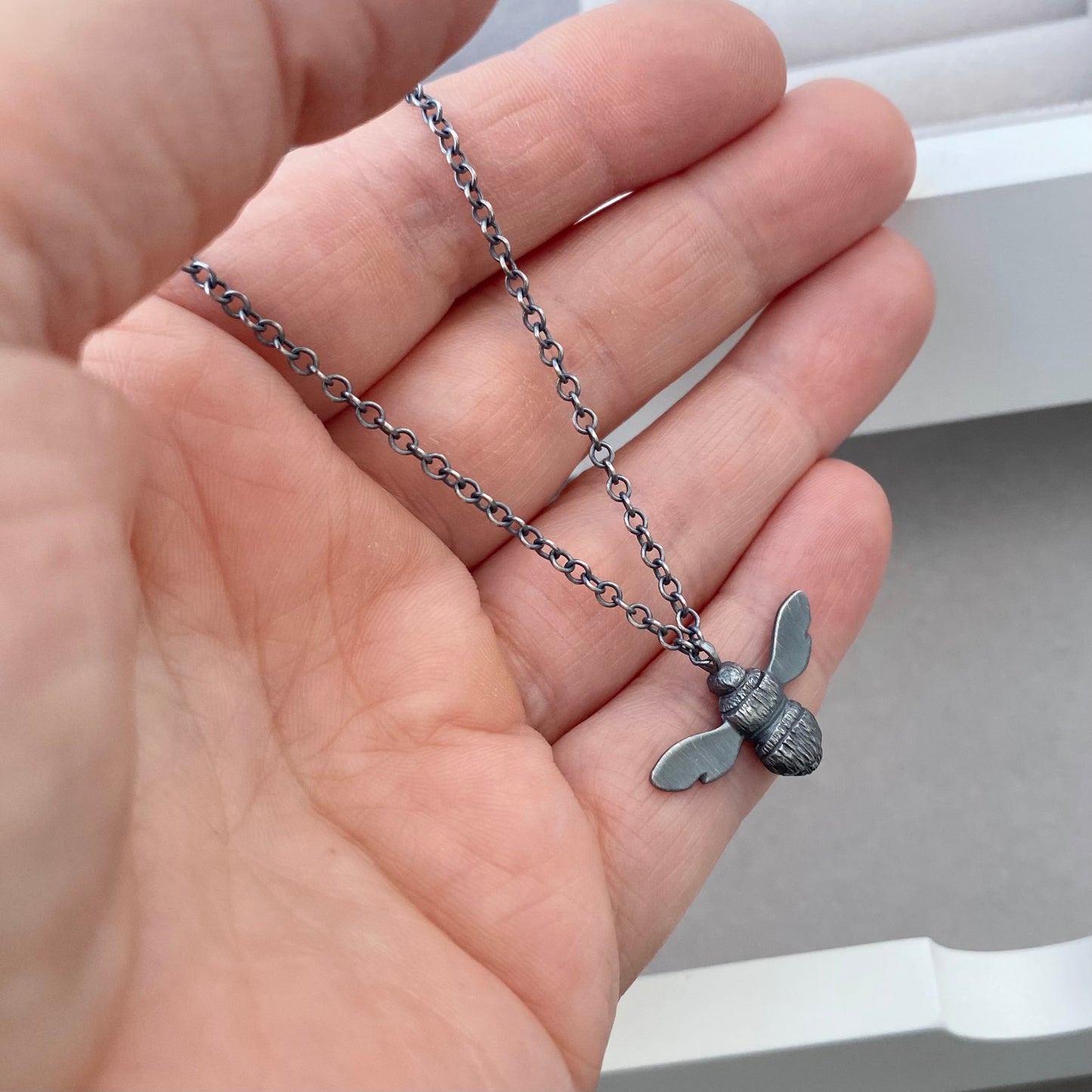 Oxidised solid sterling silver garden bumblebee pendant on a trace chain