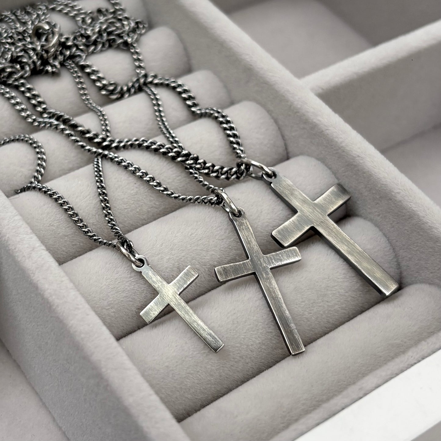 Antiqued sterling silver hammered finish small, standard, and medium cross pendants on a curb chain
