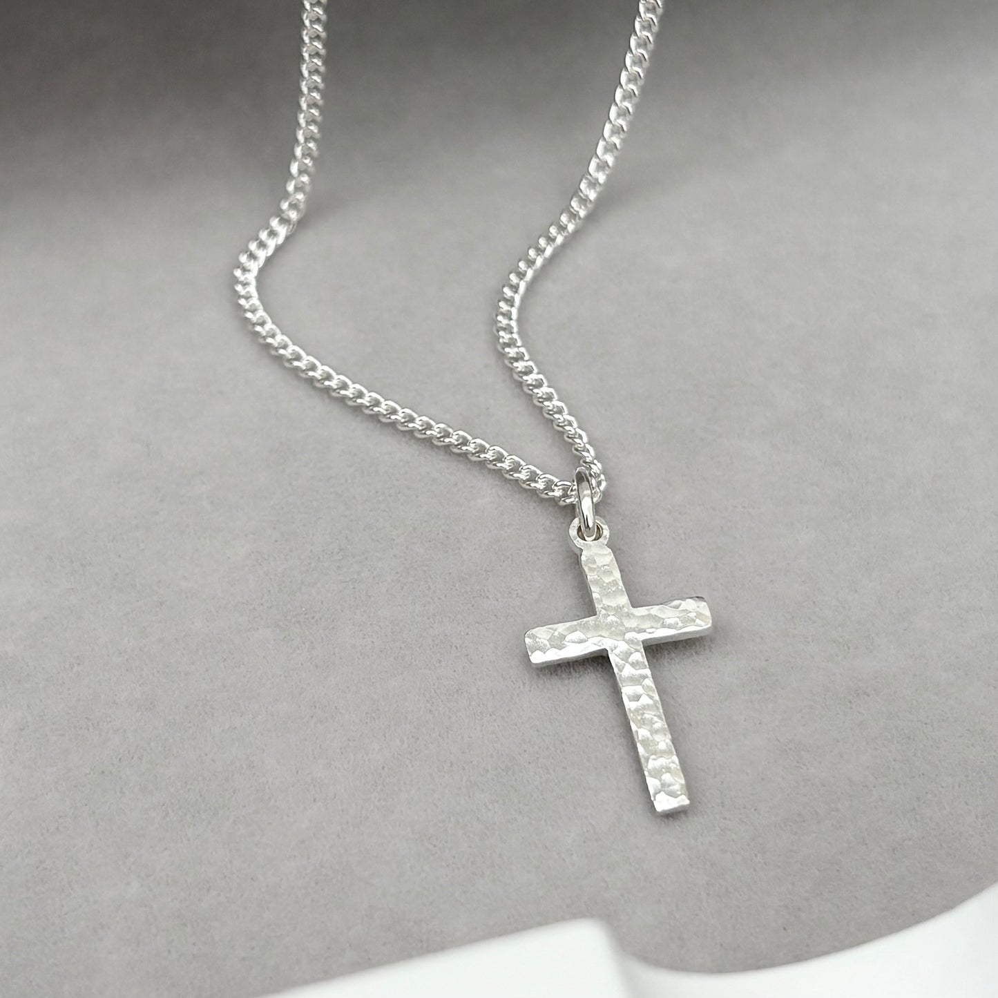 Polished sterling silver hammered finish small, standard, and medium cross pendants on a curb chain