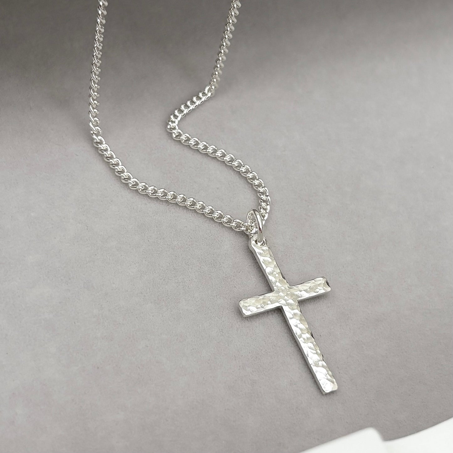 Polished sterling silver hammered finish small, standard, and medium cross pendants on a curb chain