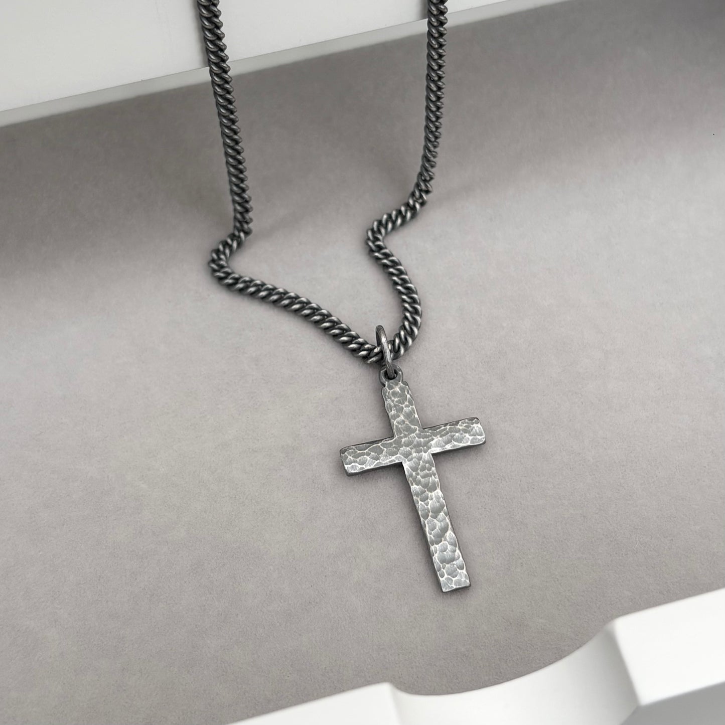 Oxidised or polished medium size sterling silver hammered cross pendant on a curb chain