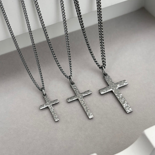 Oxidised sterling silver hammered finish small, standard, and medium cross pendants on a curb chain