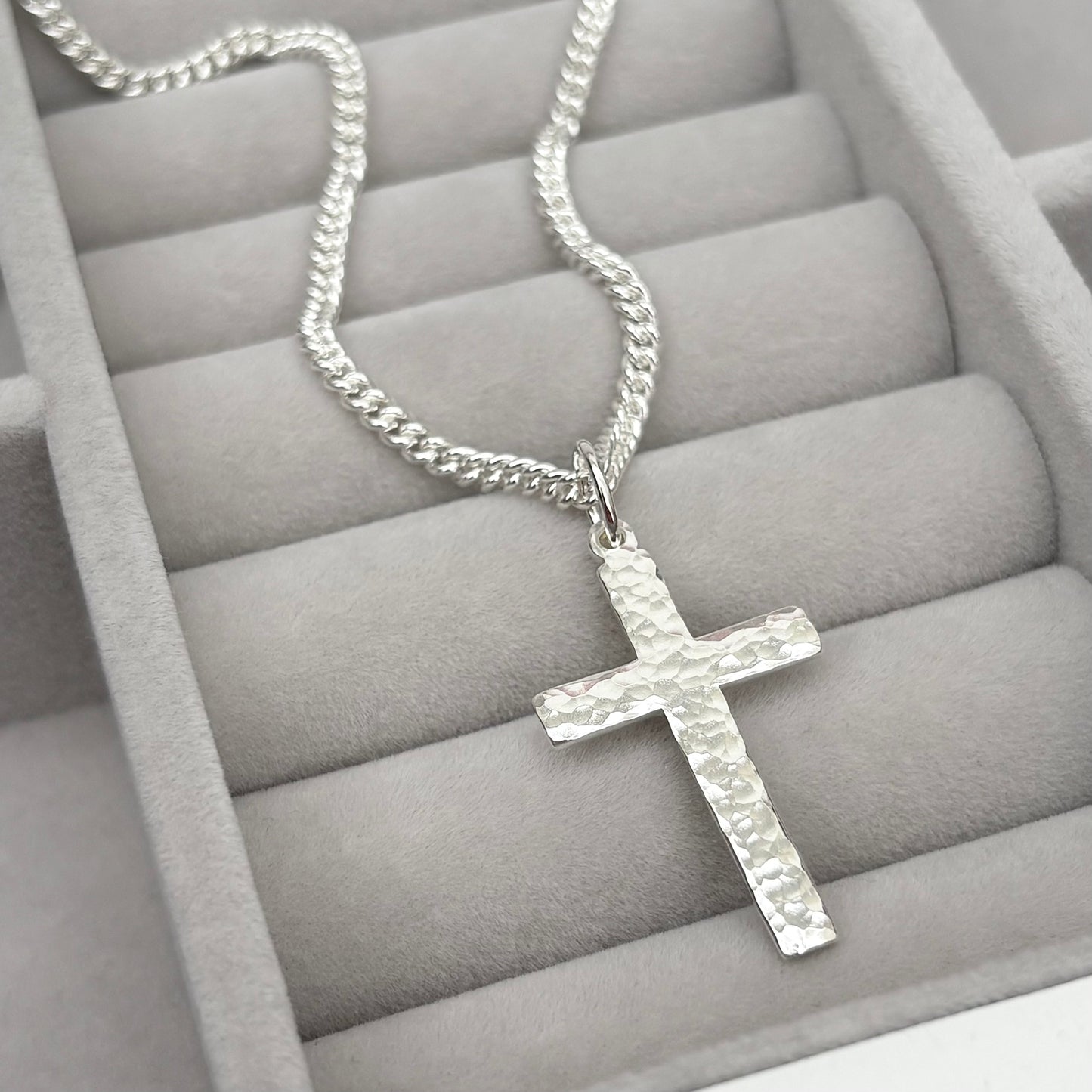Polished sterling silver hammered finish small, standard, and medium cross pendants on a curb chain