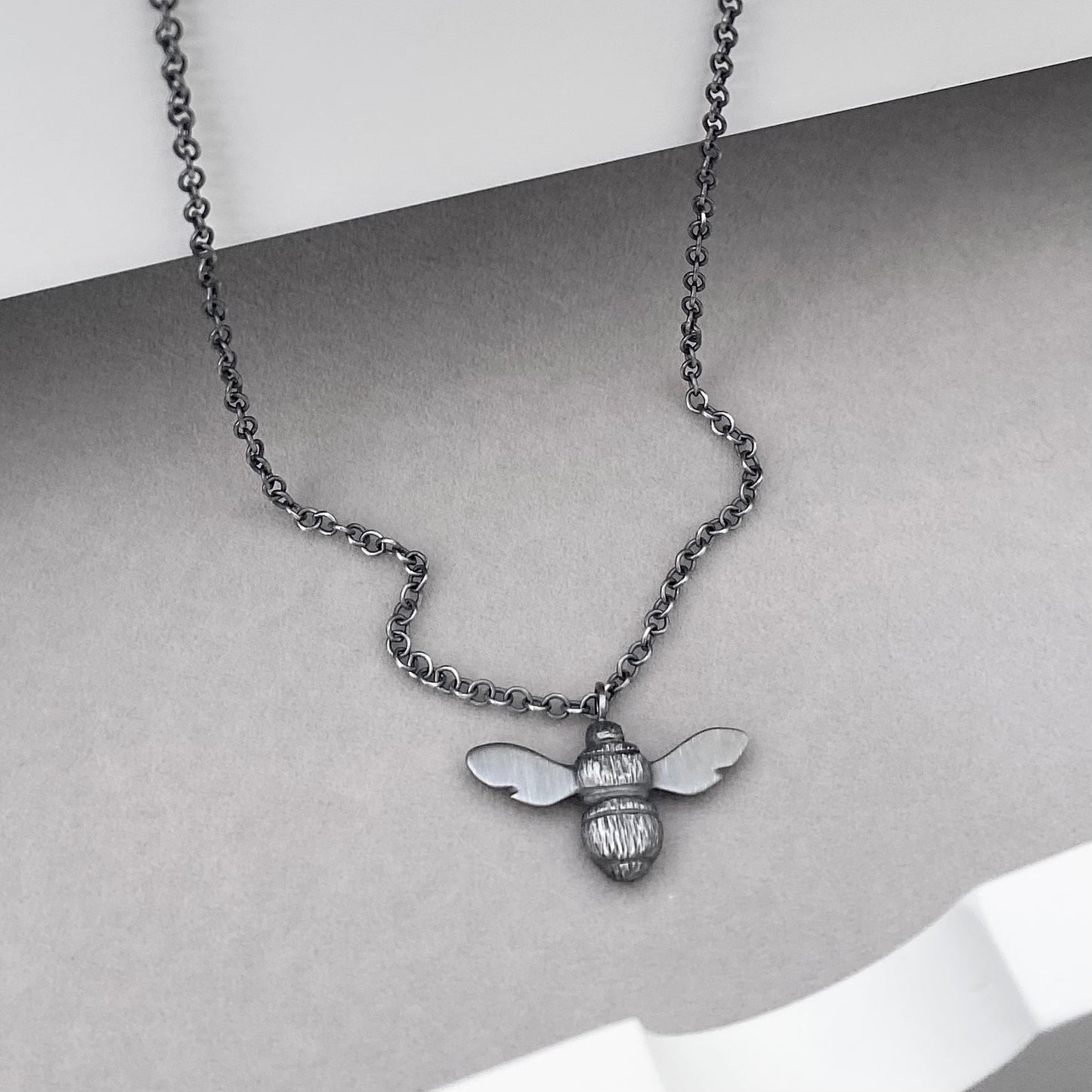 Oxidised solid sterling silver garden bumblebee pendant on a trace chain
