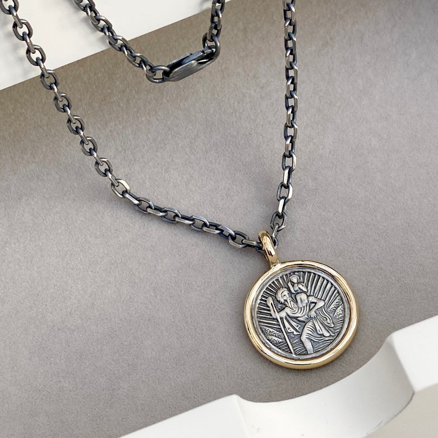 Oxidised solid silver round Saint Christopher 9ct yellow gold framed pendant on diamond cut trace chain