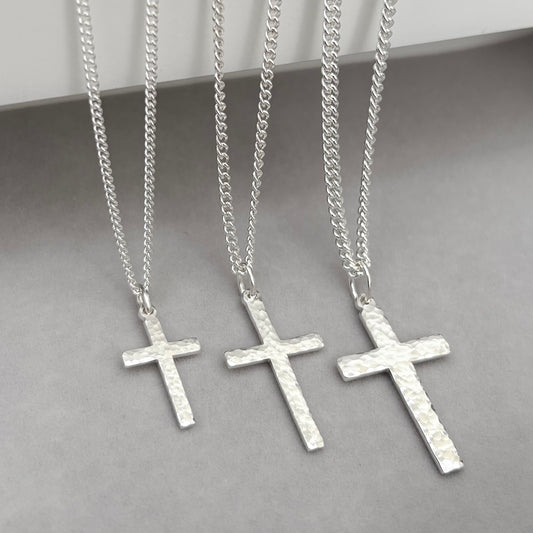 Polished sterling silver hammered finish small, standard, and medium cross pendants on a curb chain