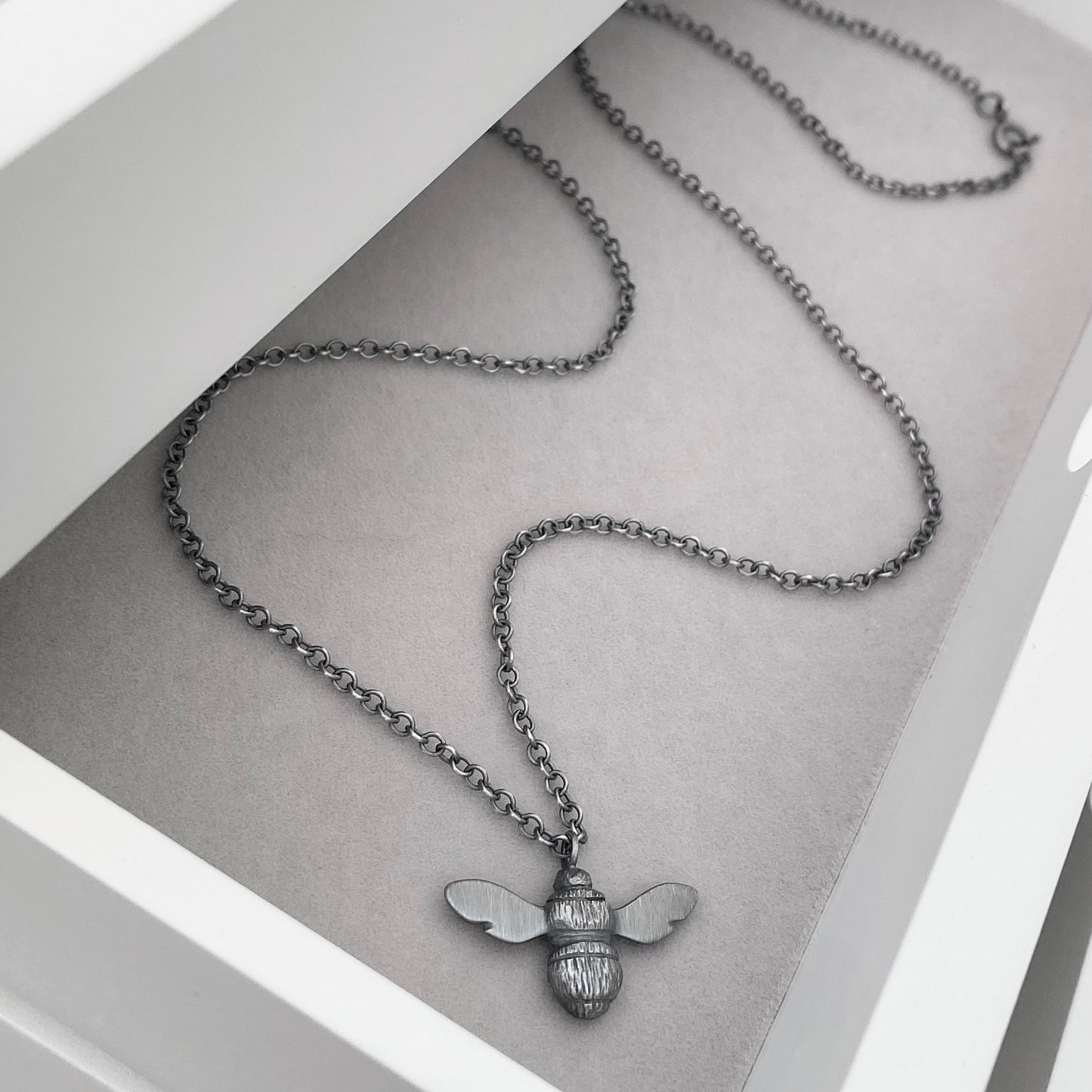 Oxidised solid sterling silver garden bumblebee pendant on a trace chain