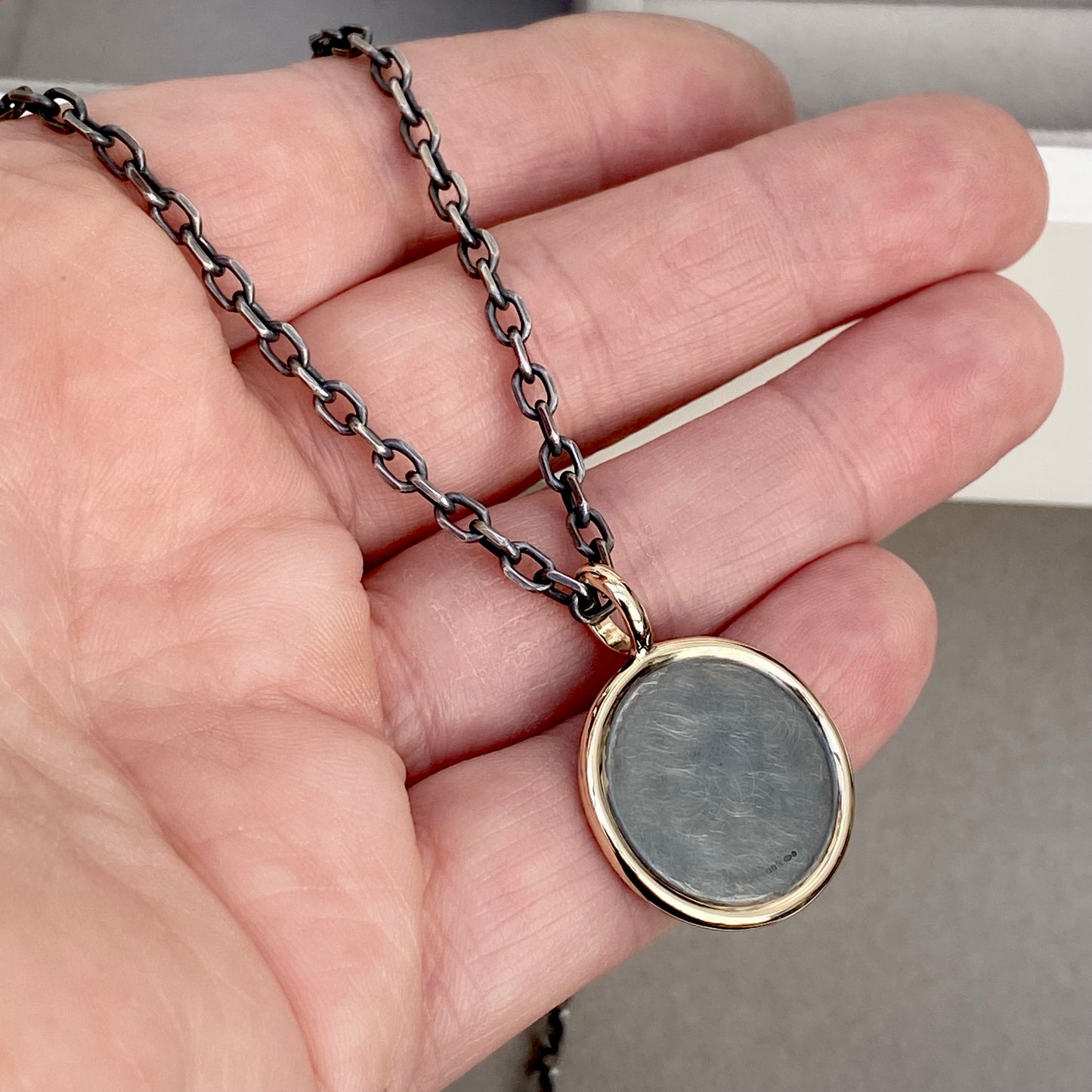 Oxidised solid silver round Saint Christopher 9ct yellow gold framed pendant on diamond cut trace chain