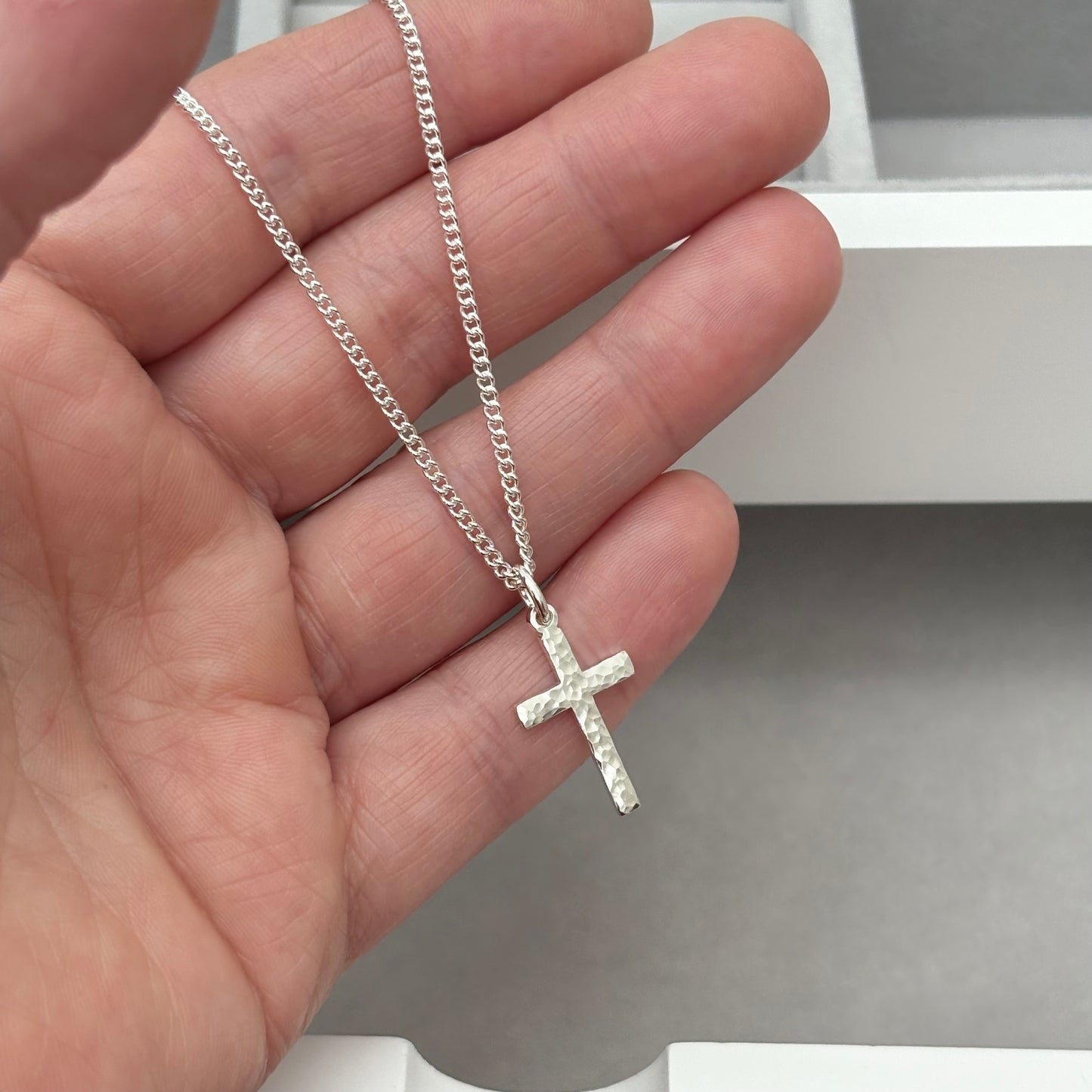 Polished sterling silver hammered finish small, standard, and medium cross pendants on a curb chain