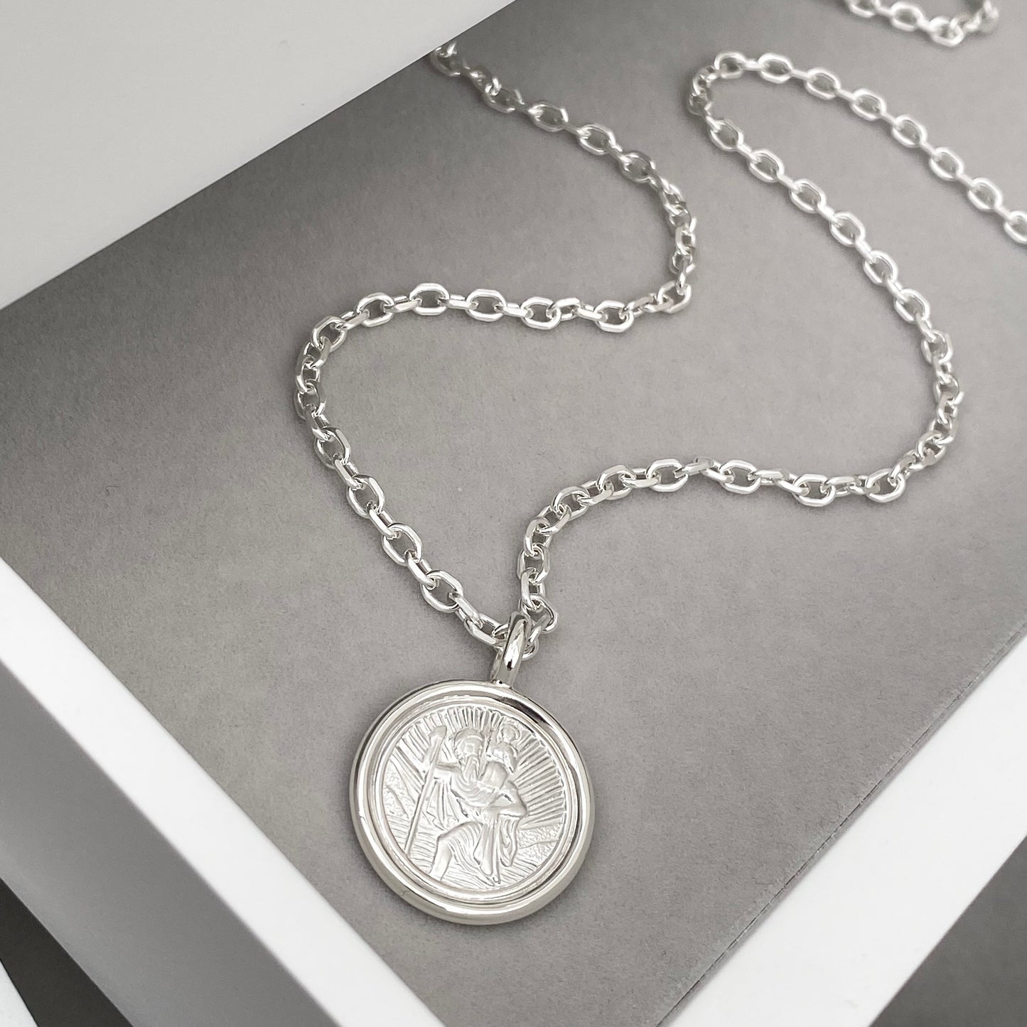 Oxidised solid silver Saint Christopher circle framed pendant on a 2.9mm wide diamond cut trace chain
