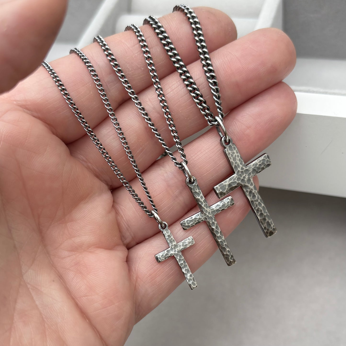 Antiqued sterling silver hammered finish small, standard, and medium cross pendants on a curb chain