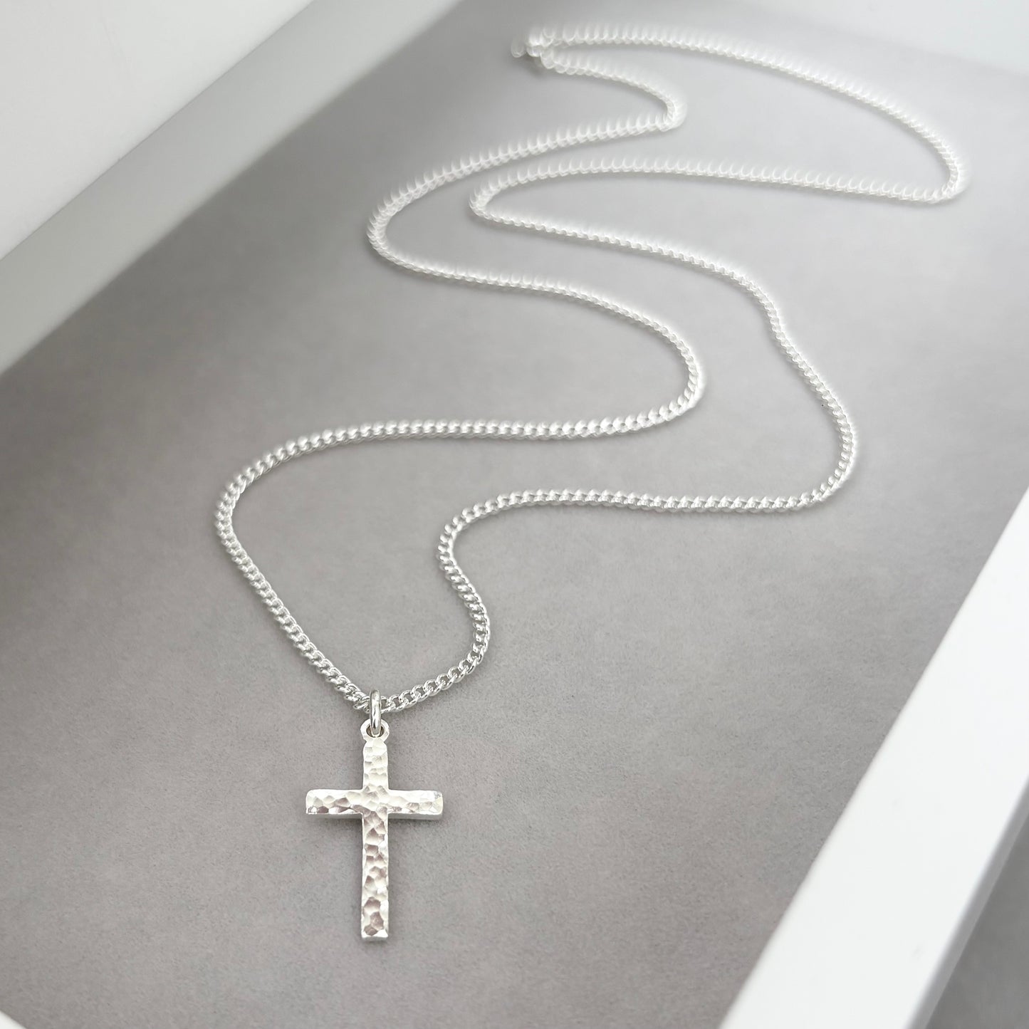 Polished sterling silver hammered finish small, standard, and medium cross pendants on a curb chain